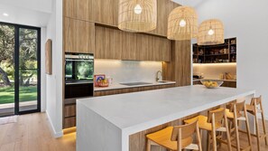 Enjoy cooking and socializing in this well-lit kitchen with a large island and oven.