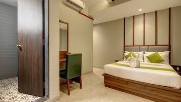 A hotel room with a wooden bed, a desk, and a chair.
