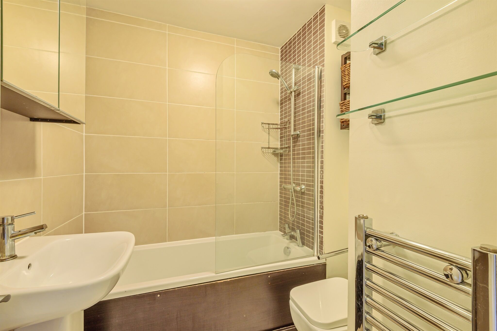A modern bathroom with a bathtub, a sink, and a toilet.