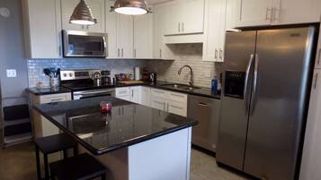 Coffee/tea maker, fridge, cookware/dishes/utensils