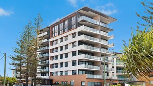 A multi-story residential building with balconies, large windows, and a modern architectural design. - Escape 201 - Beachfront Luxury in Bilinga/ North Kirra - Linen Provided (Bilinga)