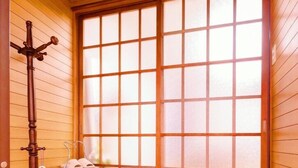 A traditional Japanese room with tatami flooring, a shoji screen door, a wooden bench, and a welcome mat. - 10mins train to Namba, 4mins walk to stn, 2floor Japanese style whole house (大阪市)