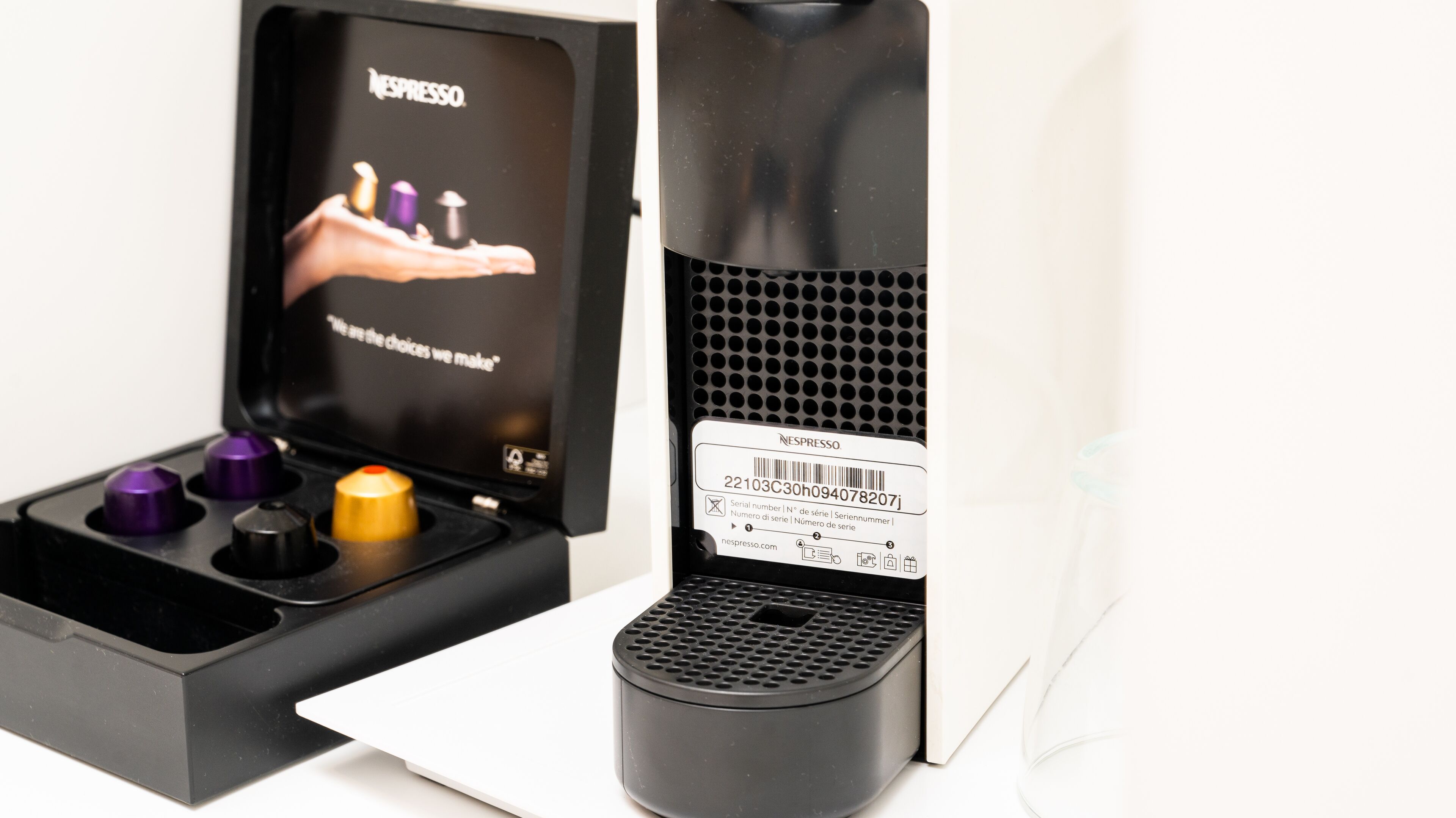 A Nespresso coffee machine with a removable drip tray and a barcode label.
