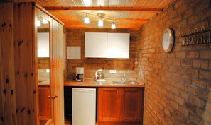 Kitchen features a dishwasher, sink, and coffee maker.