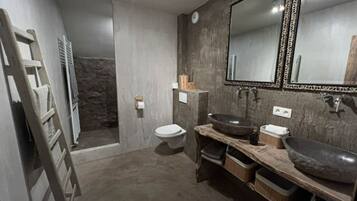 Bathtub, towels, soap, toilet paper