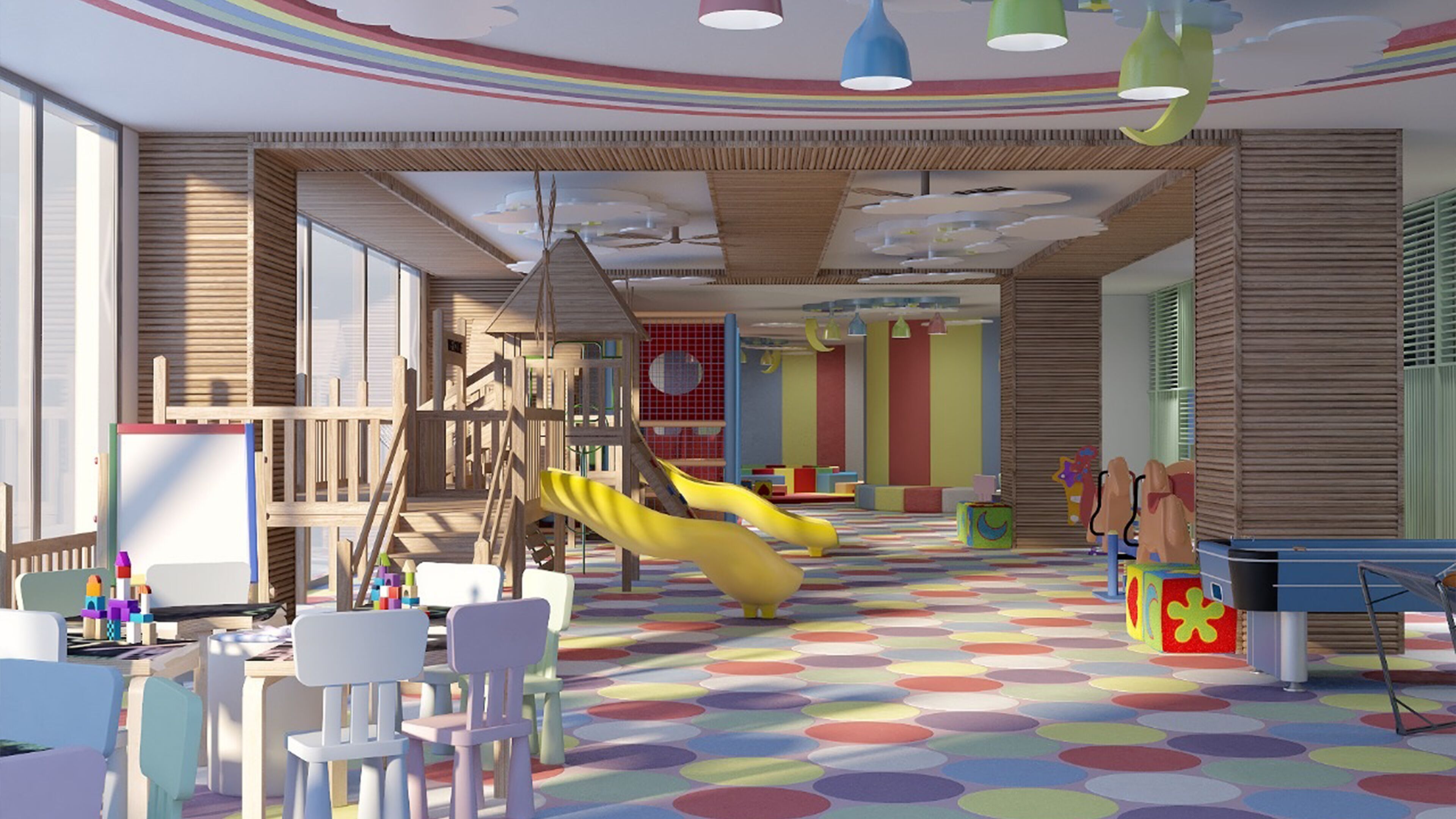 Una aula de jocs infantil amb tobogan, elements per escalar i un paviment de colors.