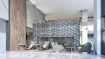 Un área de descanso moderna con un muro de diseño geométrico, asientos contemporáneos y un estilo minimalista.