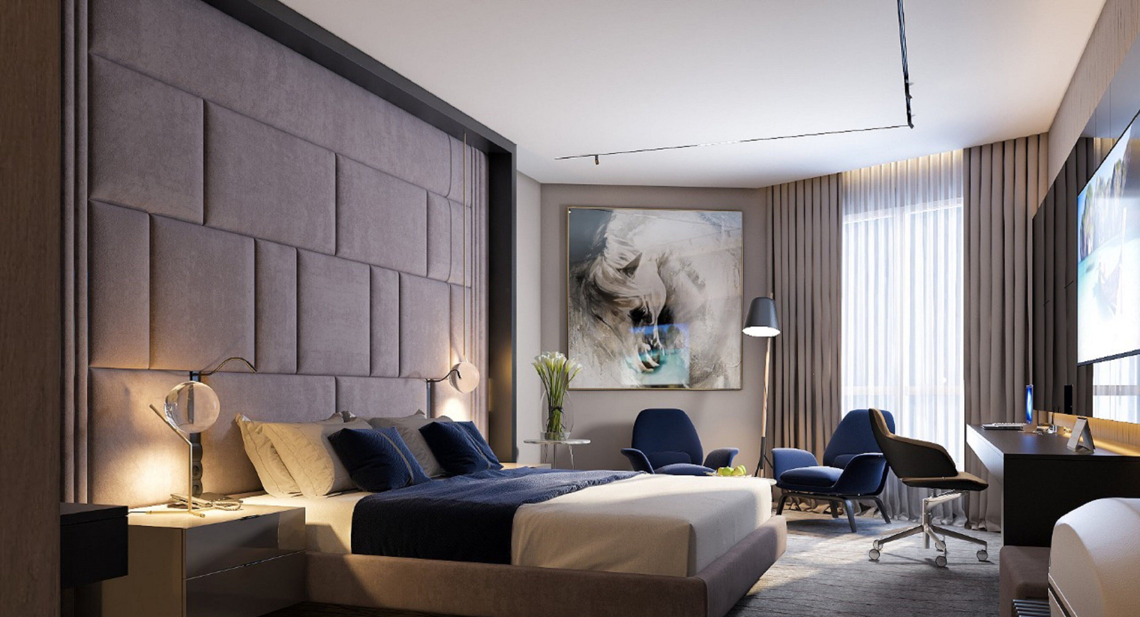A modern hotel room with a large bed, a desk, and a chair.