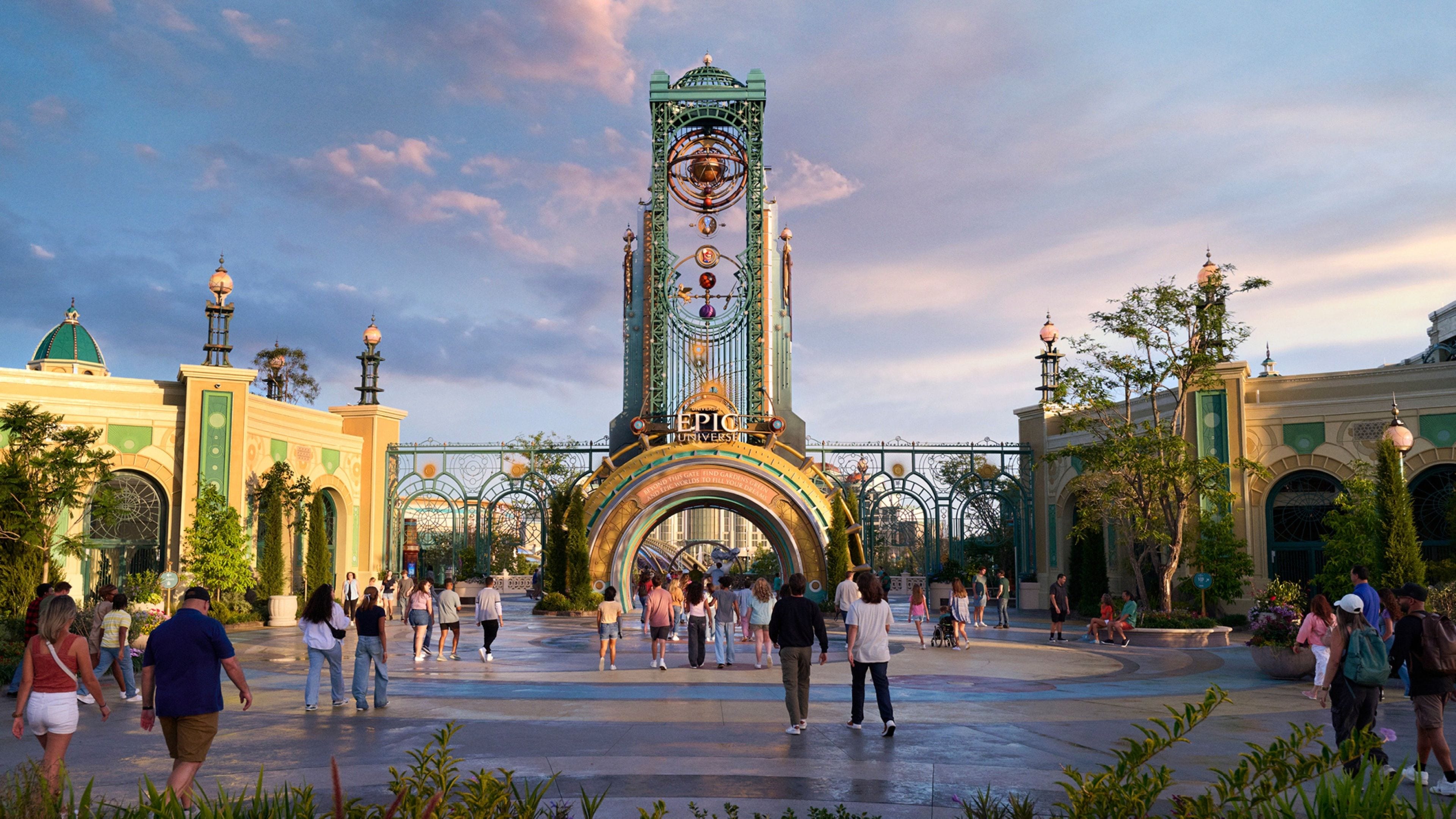 A large open plaza with a prominent clock tower in the center, surrounded by greenery and buildings with domed roofs.
