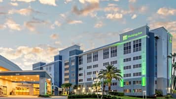 A Holiday Inn hotel with a registration area, multiple floors, and a well-lit entrance.