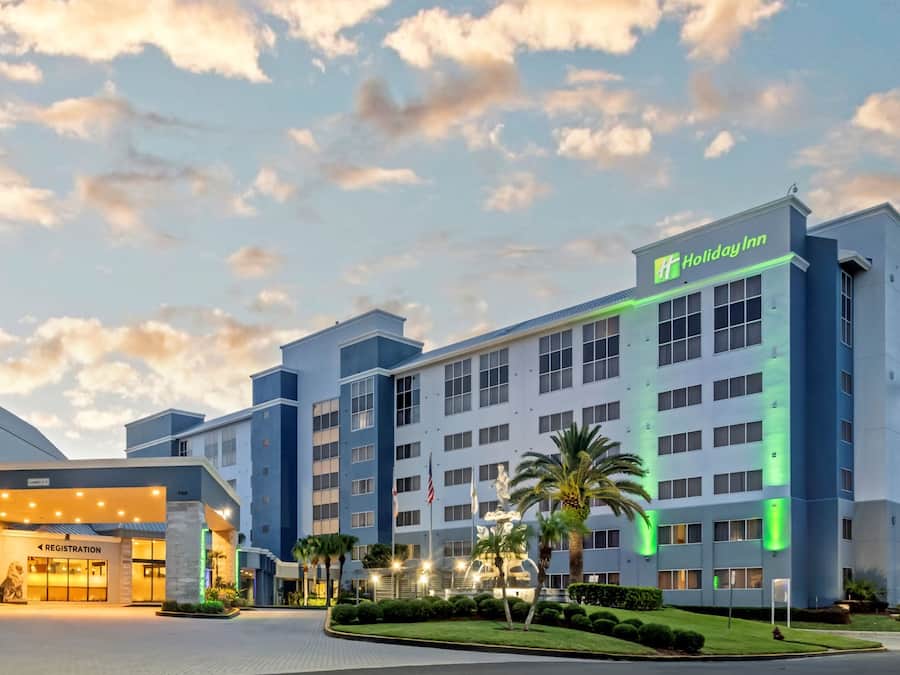 A Holiday Inn hotel with a registration area, multiple floors, and a well-lit entrance.
