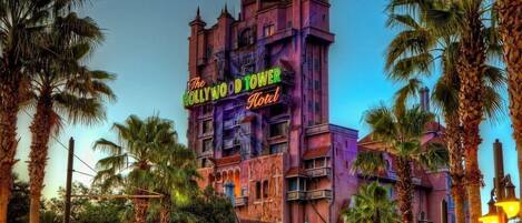 The Hollywood Tower Hotel with a gothic architectural style, featuring multiple balconies and a prominent sign.