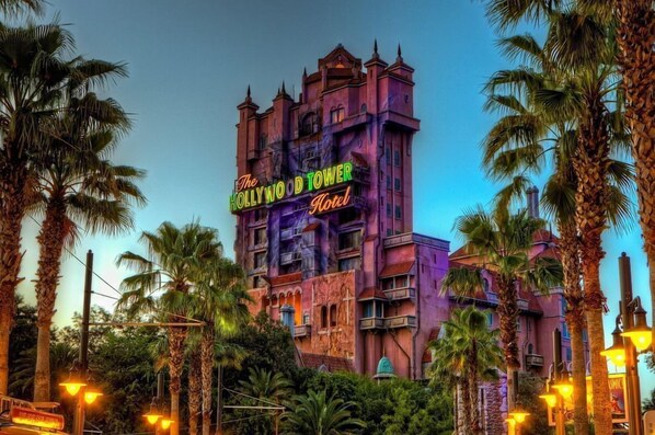 The Hollywood Tower Hotel with a gothic architectural style, featuring multiple balconies and a prominent sign. - Holiday Inn Orlando International Dr-ICON by IHG (Orlando)