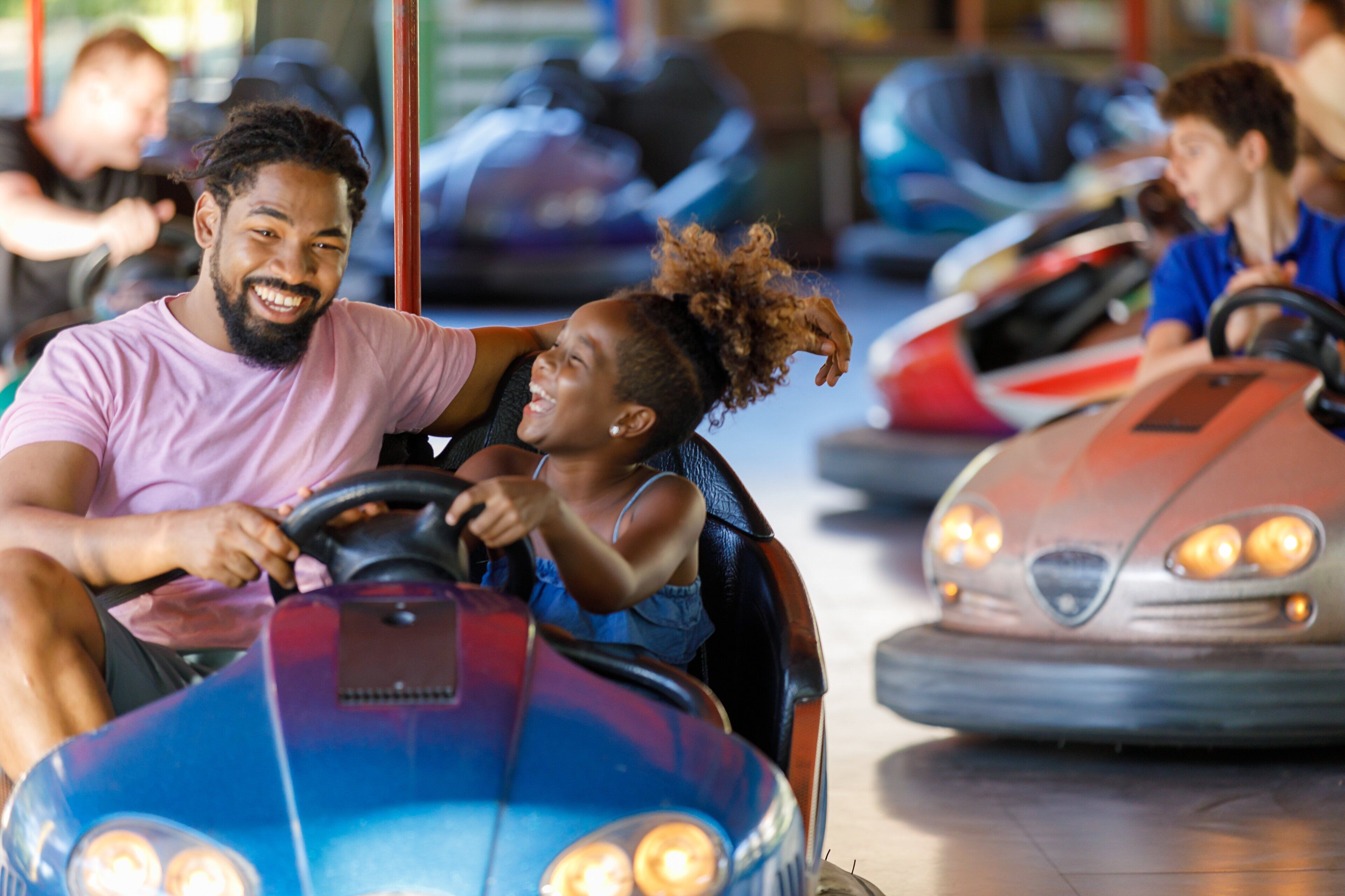 A bumper car ride with a child and an adult.