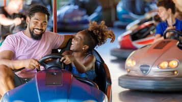 A bumper car ride with a child and an adult.
