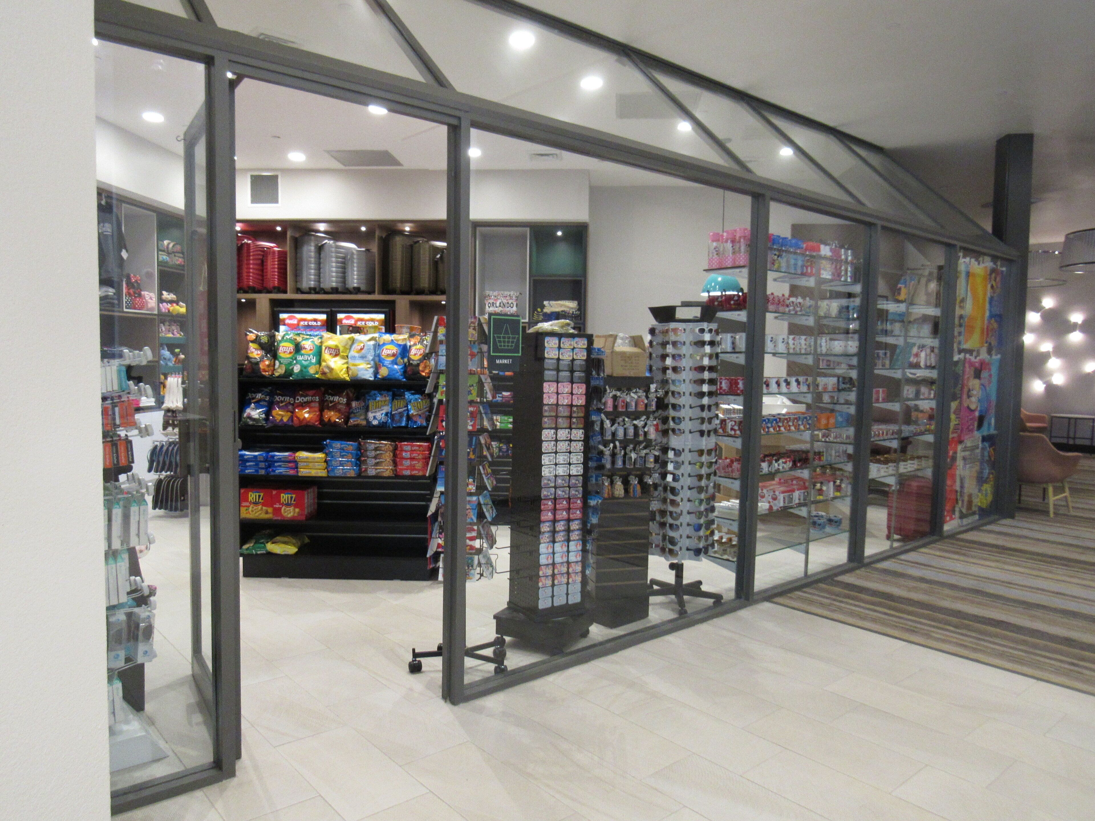 Un magasin dont les étagères sont remplies d’en-cas et où sont exposées des tasses.
