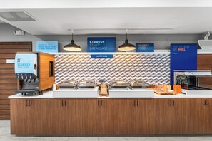 A breakfast station with a coffee machine, hot food dispensers, and a sign indicating 'EXPRESS START BREAKFAST'. - Holiday Inn Express & Suites Portland East by IHG (Portland)