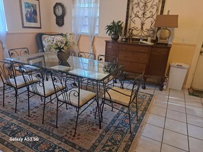 Enjoy meals in this beautifully set dining area with a glass-top table and comfortable seating for four.