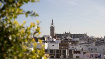 A cityscape with a prominent tower and a cathedral in the background.