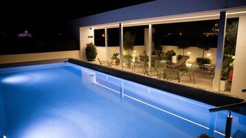 Seasonal outdoor pool, open 9:30 AM to 8:00 PM, pool umbrellas