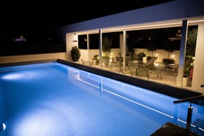 Seasonal outdoor pool, open 9:30 AM to 8:00 PM, pool umbrellas