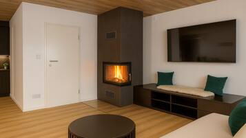 Panoramic Apartment | Living area | 170-cm Smart TV with satellite channels, TV, fireplace