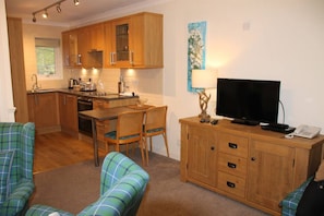 Cozy living space with a dining area, kitchenette, and comfortable sofa.