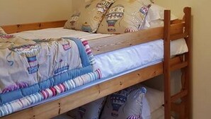A bunk bed with three levels, each with a pillow and a blanket. - Loch Rannoch Highland Club, Lochside Lodge 7 (Kinloch Rannoch)