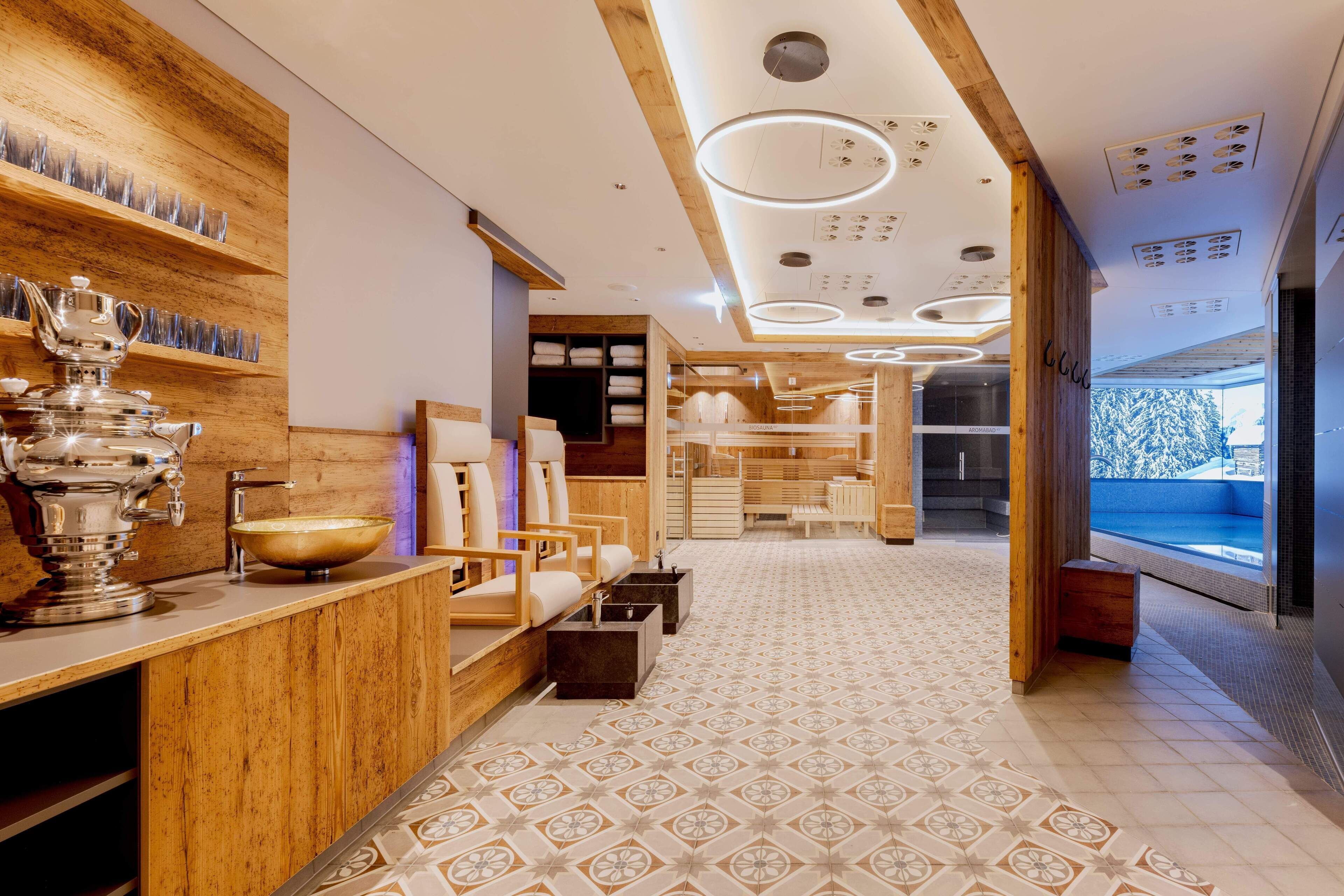 A modern spa with wooden accents, a large mirror, and a view of a snowy landscape.