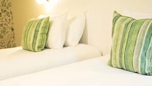 A hotel room with a bed, pillows, and a wall-mounted light fixture. - Loch Rannoch Highland Club, Red Squirrel Lodge 8 (Kinloch Rannoch)