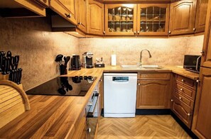 A kitchen with wooden cabinets, a dishwasher, a coffee maker, and a sink. - Loch Rannoch Highland Club. Red Squirrel 2 Lodge (Kinloch Rannoch)