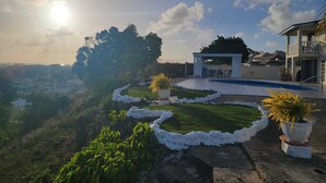 Unclassified image, 4 of 10, button - Hillside view and a pool (Bridgetown)