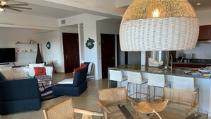 A modern living room with a sofa, chairs, and a dining area with a glass table. - Rendez-vous in St-Martin - Tropical Waves (Sint Maarten)