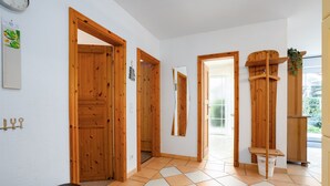 A hallway with wooden doors and a tiled floor. - Vacation apartment "Vahle 1" up to 4 persons (non-smoking) (Niendorf/Ostsee)