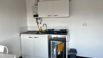 Apartment | Private kitchen | Mini-fridge, toaster, cookware/dishes/utensils, cleaning supplies