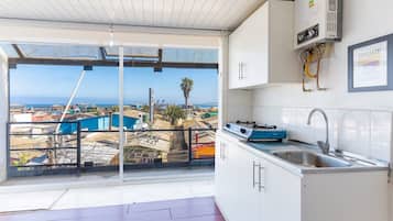 Apartment | Private kitchen | Mini-fridge, toaster, cookware/dishes/utensils, cleaning supplies