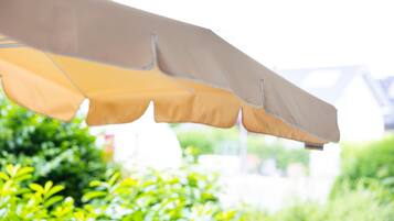 A beige outdoor umbrella.
