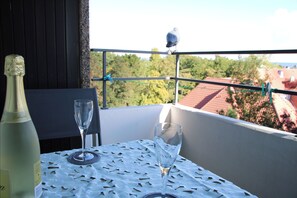 Enjoy a romantic dinner for two on the balcony with a view of the surrounding neighborhood.