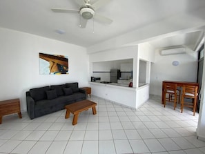 Relax in this stylish living space with a sofa, coffee table, and dining area.