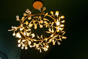 A modern chandelier with multiple light bulbs arranged in a circular pattern.