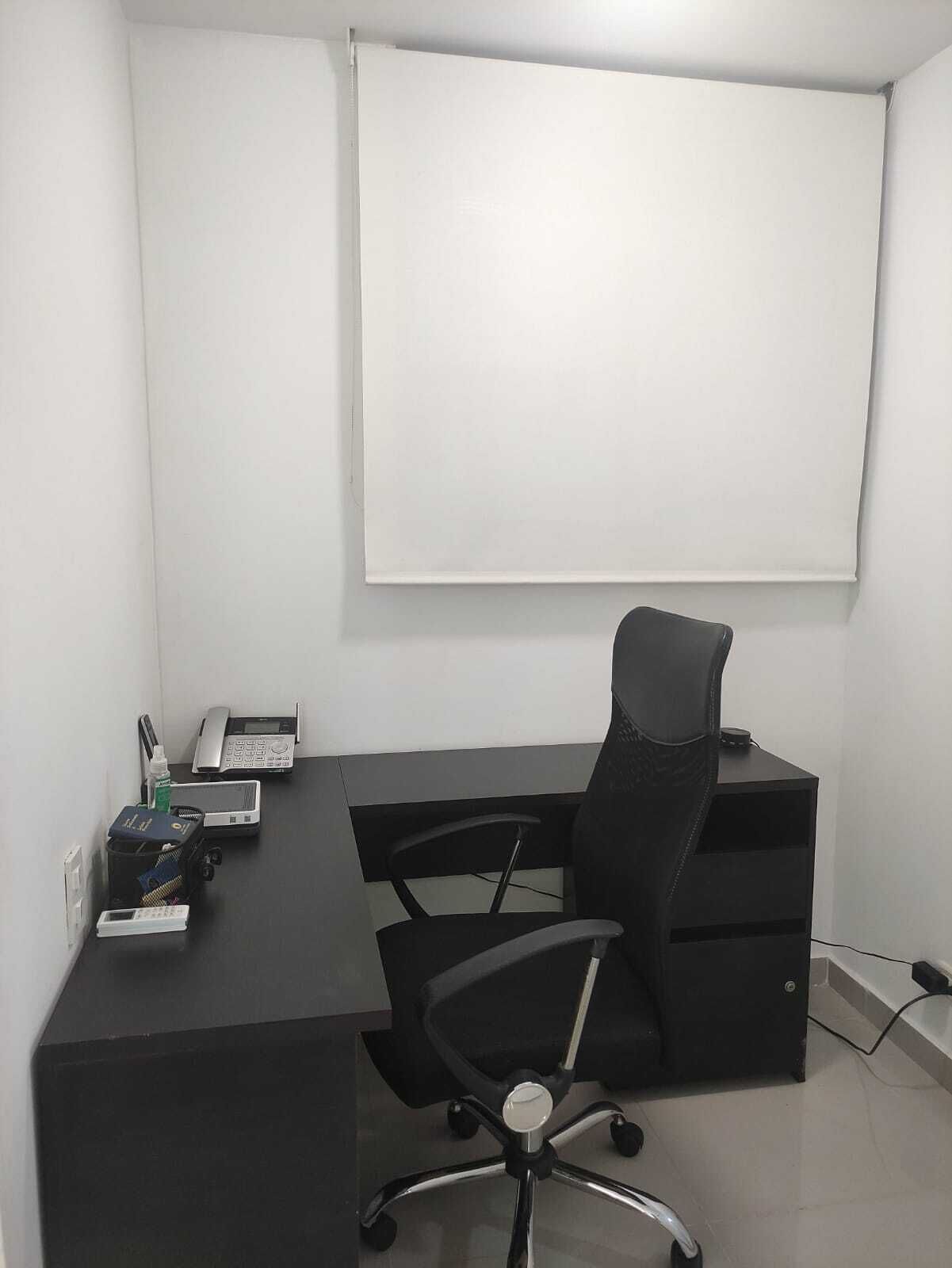 A small office with a desk, chair, and a whiteboard.