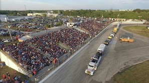 A large outdoor event with a crowd and a race track. - The Perfect Package of Space, Style and Comfort (Auburndale)
