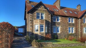 A stone building with multiple windows and a sloped roof. - The Villas No3 (Alnwick)