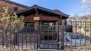 A wooden building with a sign reading "1157" and a gated entrance. - Renovated Home in Historic Downtown Durango (Durango)