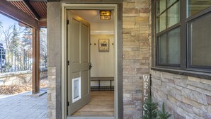 A stone exterior with a wooden door and a welcome sign. - Renovated Home in Historic Downtown Durango (Durango)