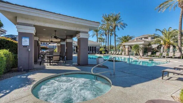 A pool area with a hot tub, lounge chairs, and a covered seating area. - North Scottsdale-Luxurious, newly-renovated condo, great location in Kierland (Scottsdale)