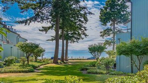 A pathway leading to a building with a clear view of the sky and trees.