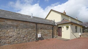 A stone building with a small attached structure. - Dairyman's Cottage (Morpeth)