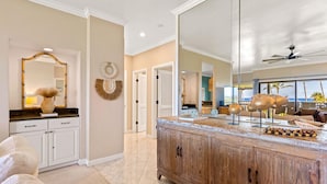 A spacious living area with a large wooden cabinet, a mirror, and a view of the outdoors. - KAUAI KONG QUARTERS OCEANVIEW 2 Bdrm 2 KINGS 1 TWIN. NextDoor2Hyatt Dining&Bars. (Koloa)