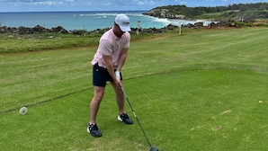 A person on a golf course with a view of the ocean and hills in the background. - KAUAI KONG QUARTERS OCEANVIEW 2 Bdrm 2 KINGS 1 TWIN. NextDoor2Hyatt Dining&Bars. (Koloa)